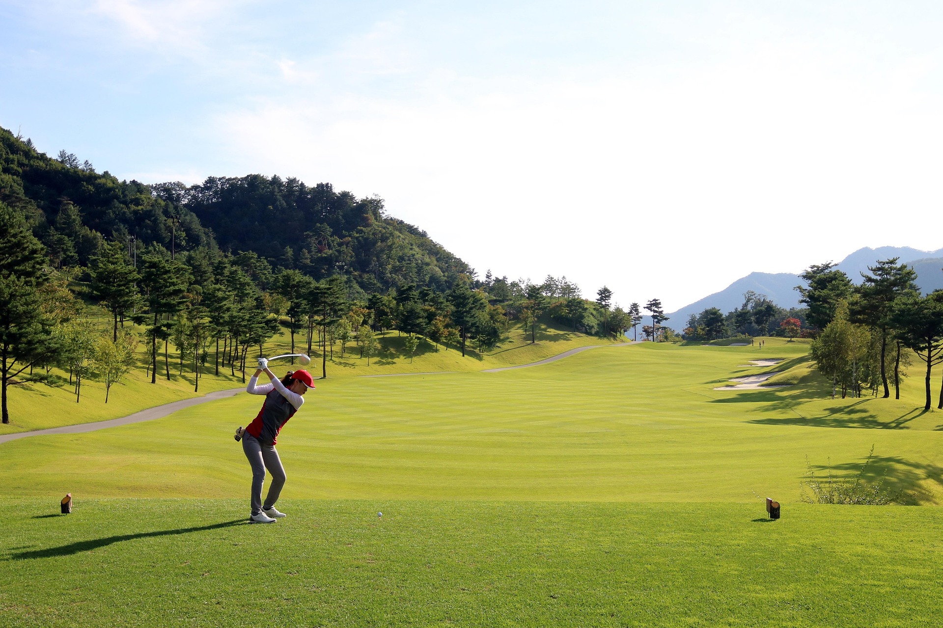 Woman on a golf course taking a golf swing