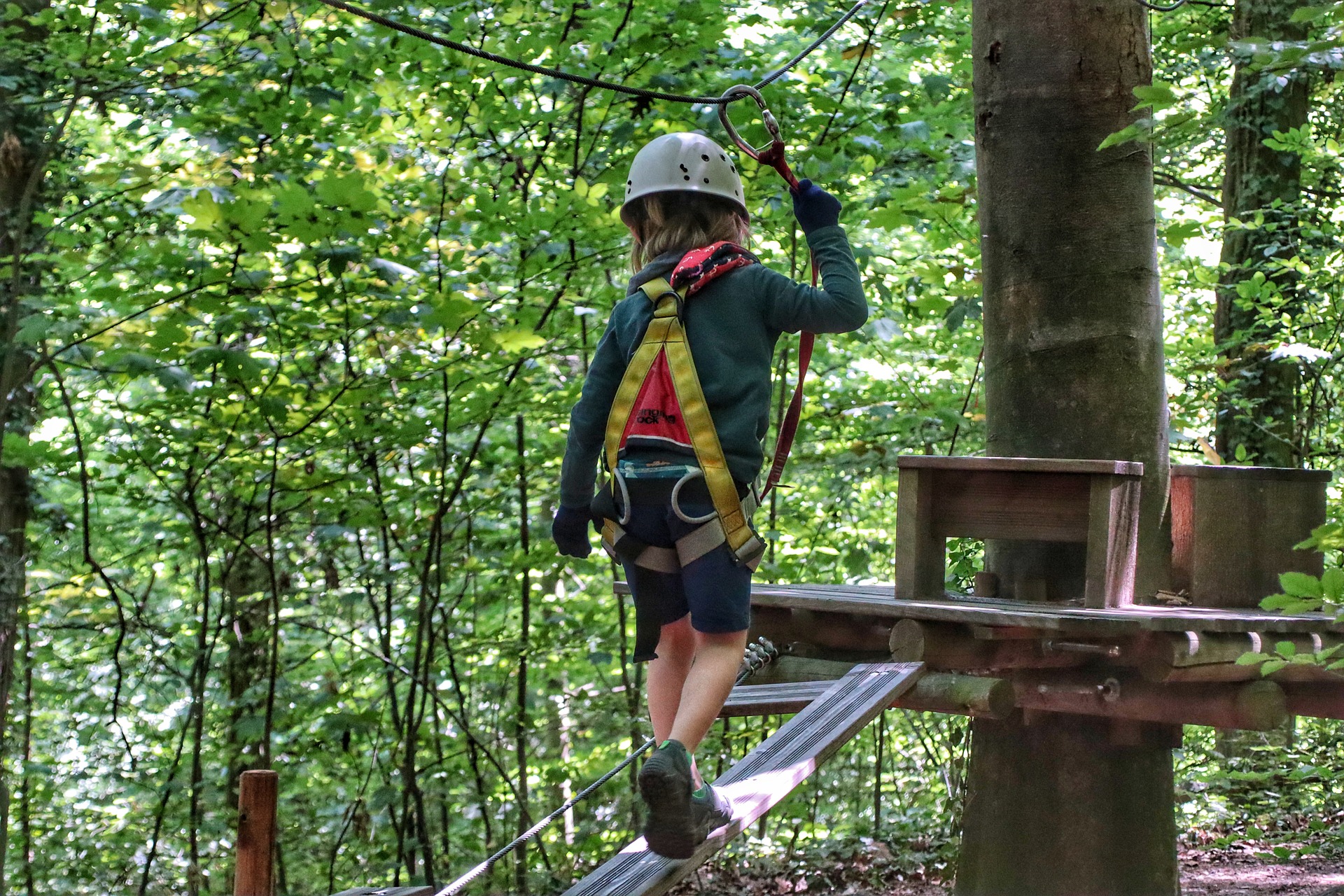 Person ziplining on a boardwalk